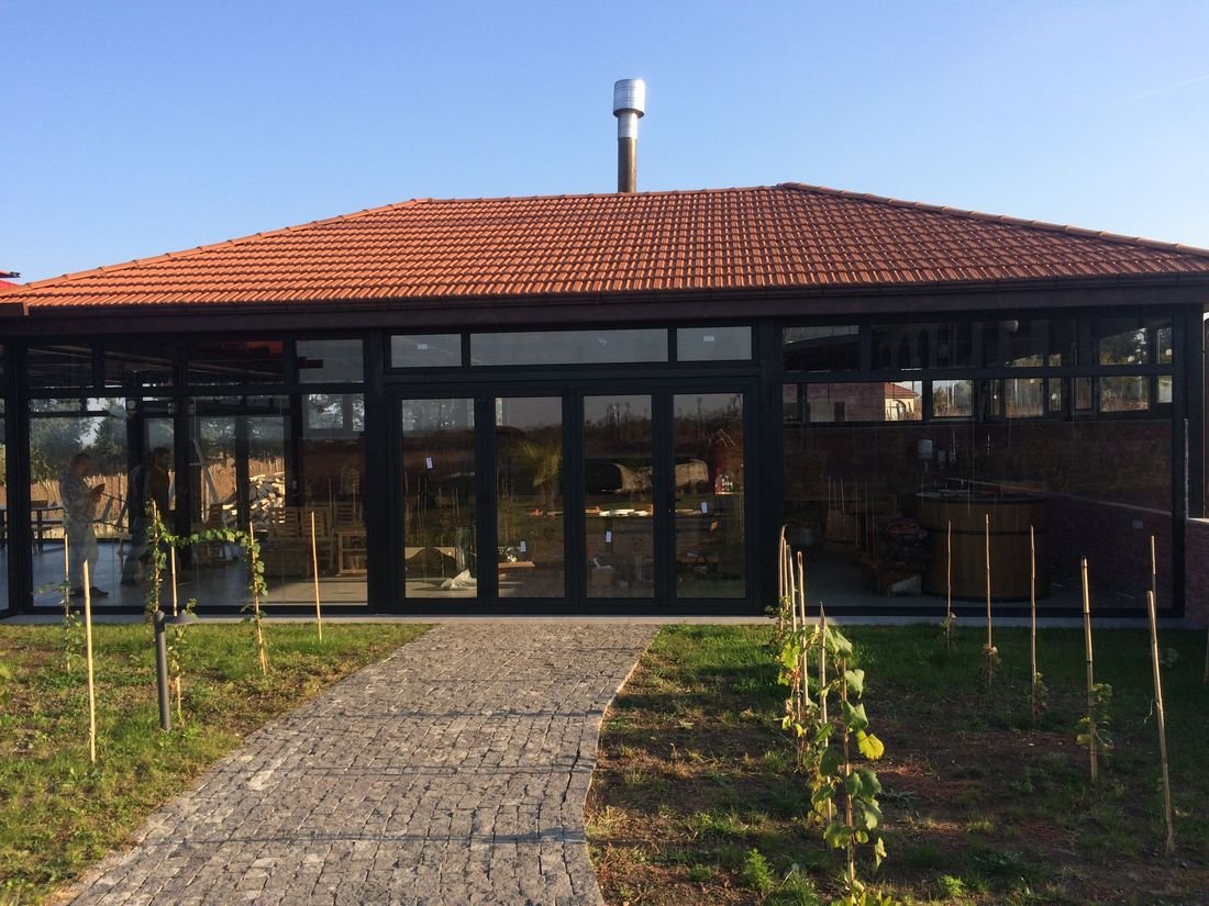 Aluminum curtain-wall system with a bi-fold opening. Restaurant and winery in Kakheti.